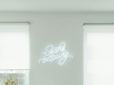 Minimalist fitness studio with blue neon lights on walls.